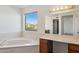 Bathroom featuring a soaking tub, a vanity area and lots of natural light at 15834 E Sunflower Dr # 1, Fountain Hills, AZ 85268