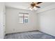 This cozy bedroom features a ceiling fan with light and a window, with neutral-colored walls and carpet at 15834 E Sunflower Dr # 1, Fountain Hills, AZ 85268