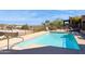 Community pool with a clear blue surface surrounded by an iron fence at 15834 E Sunflower Dr # 1, Fountain Hills, AZ 85268