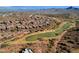 Stunning aerial view of houses overlooking a golf course and mountain range at 16210 E Links Dr, Fountain Hills, AZ 85268