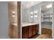 Bathroom featuring double sinks, a vanity, and a tiled walk-in shower at 16210 E Links Dr, Fountain Hills, AZ 85268