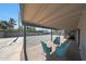 Covered patio with brick flooring and furniture overlooking a large, fenced backyard at 1709 W Clarendon Ave, Phoenix, AZ 85015