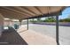 Covered patio with brick flooring and furniture overlooking a large, fenced backyard at 1709 W Clarendon Ave, Phoenix, AZ 85015