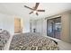 Bright bedroom with ceiling fan, a large sliding glass door, and an ensuite bathroom with a tiled shower at 1709 W Clarendon Ave, Phoenix, AZ 85015