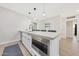 Kitchen island features white cabinets, stainless microwave and modern fixtures at 1709 W Clarendon Ave, Phoenix, AZ 85015