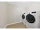 Bright laundry room features tile floors and modern, front-loading washing machine and dryer at 1709 W Clarendon Ave, Phoenix, AZ 85015