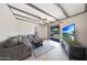 Cozy living room with beamed ceiling, tile flooring, comfortable seating and glass doors to the backyard at 1709 W Clarendon Ave, Phoenix, AZ 85015