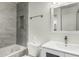 Modern bathroom with neutral tile surround bathtub, gray and white vanity, and recessed lighting at 1717 E Union Hills Dr # 1065, Phoenix, AZ 85024