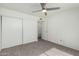 Carpeted bedroom with a large sliding-door closet, doorway and standard door at 1717 E Union Hills Dr # 1065, Phoenix, AZ 85024