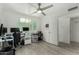 Home office with large window, ceiling fan, desk setup, leading into other carpeted rooms at 1717 E Union Hills Dr # 1065, Phoenix, AZ 85024