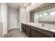 A bright bathroom offers dual sinks, a large mirror, and a glass-enclosed shower at 17843 W Encinas Ln, Goodyear, AZ 85338