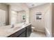 Bathroom featuring double sinks, modern fixtures, tile floor, and shower-tub combo at 17843 W Encinas Ln, Goodyear, AZ 85338