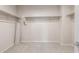 A spacious walk-in closet featuring carpet and built-in shelving for optimal organization at 17843 W Encinas Ln, Goodyear, AZ 85338