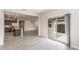 Open-concept living space with tile flooring, connecting the kitchen, dining, and living areas at 17843 W Encinas Ln, Goodyear, AZ 85338