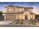 Inviting two-story home featuring a neutral color palette, tile roof, and charming desert landscaping at 18150 E Colt Dr, Queen Creek, AZ 85142