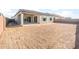 The backyard features a covered patio and newly seeded area ready for landscaping at 18166 E Colt Dr, Queen Creek, AZ 85142