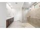 A modern bathroom features a double vanity and a large glass-enclosed shower at 18166 E Colt Dr, Queen Creek, AZ 85142