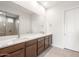 The bathroom features a double vanity with a white countertop and dark wood cabinets at 18166 E Colt Dr, Queen Creek, AZ 85142