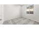 Comfortable bedroom with gray carpeting and a window offering natural light at 18166 E Colt Dr, Queen Creek, AZ 85142