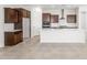 Modern kitchen features a large island, white countertops, dark wood cabinets, and stainless appliances at 18166 E Colt Dr, Queen Creek, AZ 85142