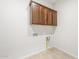 Functional laundry room with upper cabinetry and hookups for washer and dryer at 18166 E Colt Dr, Queen Creek, AZ 85142