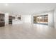Spacious living area with tile flooring, leading into a kitchen with modern appliances and backyard views at 18166 E Colt Dr, Queen Creek, AZ 85142