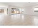 Bright living room featuring tile floors, large windows, and sliding glass doors to backyard at 18166 E Colt Dr, Queen Creek, AZ 85142