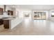 Open-concept living area featuring tile floors, abundant natural light, and backyard access at 18166 E Colt Dr, Queen Creek, AZ 85142