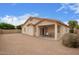 Cozy backyard with patio, perfect for outdoor seating and relaxation, with a low-maintenance desert landscape at 18415 W Port Au Prince Ln, Surprise, AZ 85388