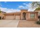 Charming single-story home featuring a three-car garage and well-maintained desert landscaping at 18415 W Port Au Prince Ln, Surprise, AZ 85388