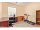 Office features a treadmill and built-in storage at 18415 W Port Au Prince Ln, Surprise, AZ 85388