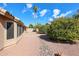 Spacious backyard featuring mature trees, gravel landscaping, and a covered patio, ideal for enjoying the outdoors at 19507 N 90Th Ln, Peoria, AZ 85382