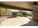 Covered backyard patio featuring a concrete area and decorative landscaping, perfect for outdoor relaxation and entertaining at 19507 N 90Th Ln, Peoria, AZ 85382