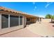 Covered backyard patio overlooking a gravel-landscaped yard with mature trees, perfect for outdoor relaxation at 19507 N 90Th Ln, Peoria, AZ 85382