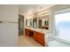 Bathroom featuring double sinks, granite counters and a soaking tub at 19507 N 90Th Ln, Peoria, AZ 85382