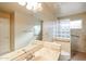 Bathroom featuring tiled walls, updated fixtures, and glass block at 19507 N 90Th Ln, Peoria, AZ 85382