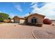 Well-maintained home features desert landscaping with colorful shrubbery, a two-car garage, and a neatly kept exterior at 19507 N 90Th Ln, Peoria, AZ 85382