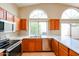 Well-lit kitchen area with stainless steel appliances, white countertops, and wood cabinets at 19507 N 90Th Ln, Peoria, AZ 85382