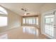 Bright living room with high ceilings, ceiling fan, and a multitude of windows that let in natural light at 19507 N 90Th Ln, Peoria, AZ 85382