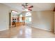 Open concept living room showcasing wood floors, lots of natural light, and connecting to the kitchen at 19507 N 90Th Ln, Peoria, AZ 85382