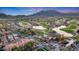 Expansive aerial view of the community, showcasing a golf course, ponds, upscale homes and mountain views at 21141 W Main St, Buckeye, AZ 85396