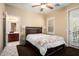 Bedroom featuring ensuite bathroom, ceiling fan, and patio access at 21141 W Main St, Buckeye, AZ 85396