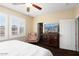 Bedroom featuring a ceiling fan, a large window, and a walk-in closet at 21141 W Main St, Buckeye, AZ 85396