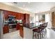 Well-appointed kitchen featuring stainless steel appliances, dark wood cabinetry and an island with bar seating at 21141 W Main St, Buckeye, AZ 85396