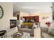 Open concept living room featuring a fireplace and view into the modern kitchen with stainless appliances at 21141 W Main St, Buckeye, AZ 85396