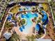 Aerial view of resort-style pool with cabanas, palm trees, and ample seating at 21141 W Main St, Buckeye, AZ 85396