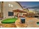 Expansive backyard with pool, covered patio, putting green, and comfortable seating areas at 22412 N 20Th Pl, Phoenix, AZ 85024