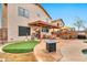 Relaxing outdoor area with putting green, seating, a grill, and covered patio at 22412 N 20Th Pl, Phoenix, AZ 85024