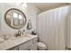 Clean bathroom with a vanity, round mirror, and shower with curtain at 22412 N 20Th Pl, Phoenix, AZ 85024