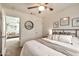 Neutral bedroom features a ceiling fan and simple decor, with an open doorway to the living area at 22412 N 20Th Pl, Phoenix, AZ 85024